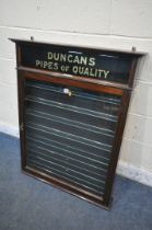 AN EARLY 20TH CENTURY MAHOGANY SINGLE DOOR DUNCAN'S PIPES OF QUALITY DISPLAY CASE, enclosing seven