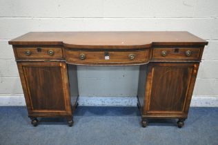 A GEORGIAN MAHOGANY AND CROSSBANDED PEDESTAL SIDEBOARD, central bowfront section, three frieze