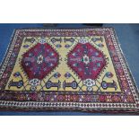 A LARGE PERSIAN KAZAK RUG, two conjoined medallions, surrounded by geometric detail, 256cm x