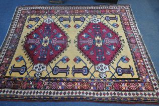 A LARGE PERSIAN KAZAK RUG, two conjoined medallions, surrounded by geometric detail, 256cm x