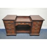 AN EDWARDIAN MAHOGANY DESK, fitted with nine drawers, on casters, width 152cm x depth 56cm x