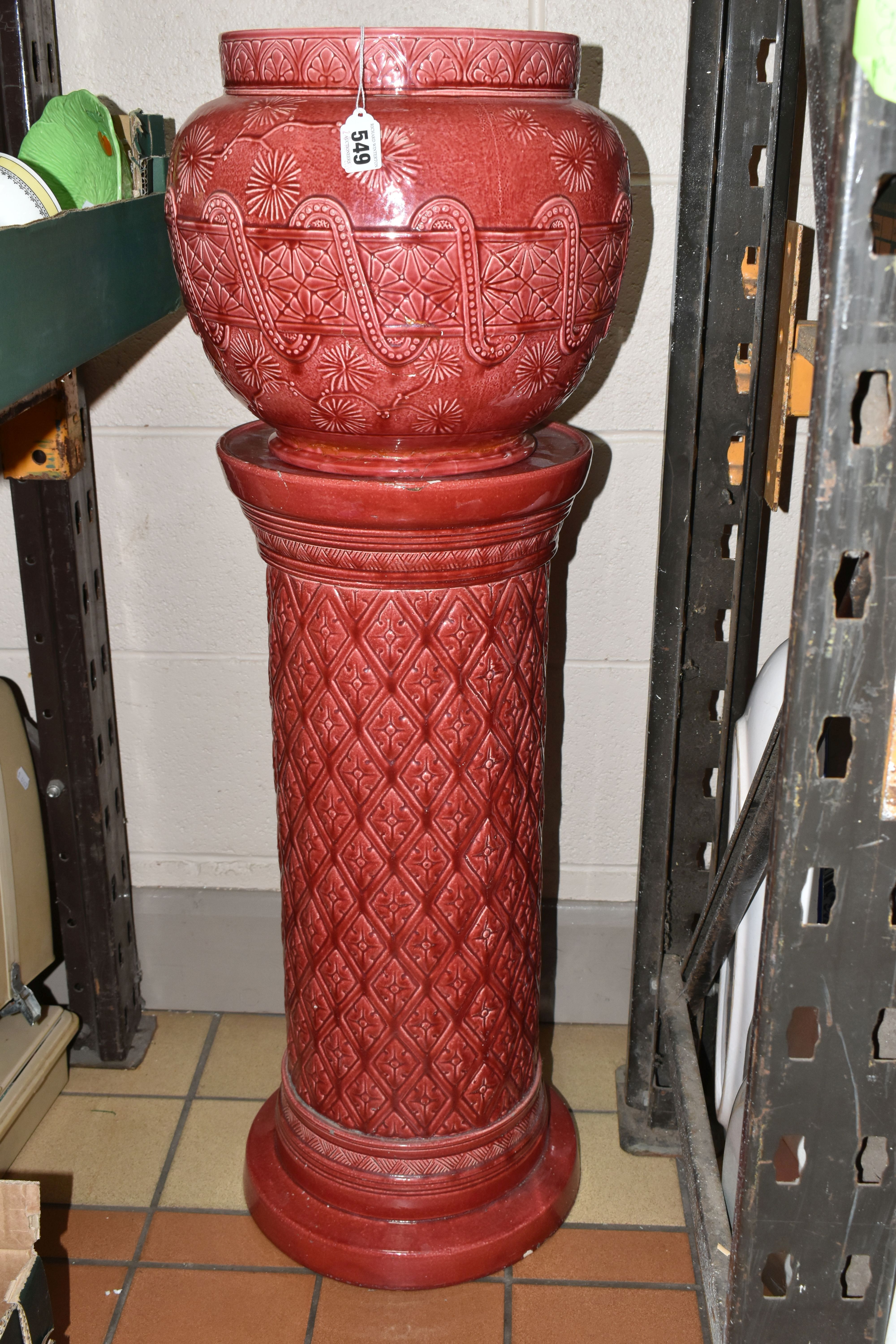 A LARGE RED BURMANTOFT JARDINIERE AND A SIMILAR COLOURED STAND, impressed marks to the base of the