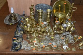 A LARGE COLLECTION OF BRASSWARE INCLUDING SERVING TRAYS with Indo-Persian motifs, a large range of