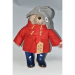 A GABRIELLE DESIGN PADDINGTON BEAR, wearing red duffle coat, blue hat and blue 'Dunlop' wellies,