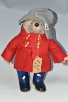 A GABRIELLE DESIGN PADDINGTON BEAR, wearing red duffle coat, blue hat and blue 'Dunlop' wellies,