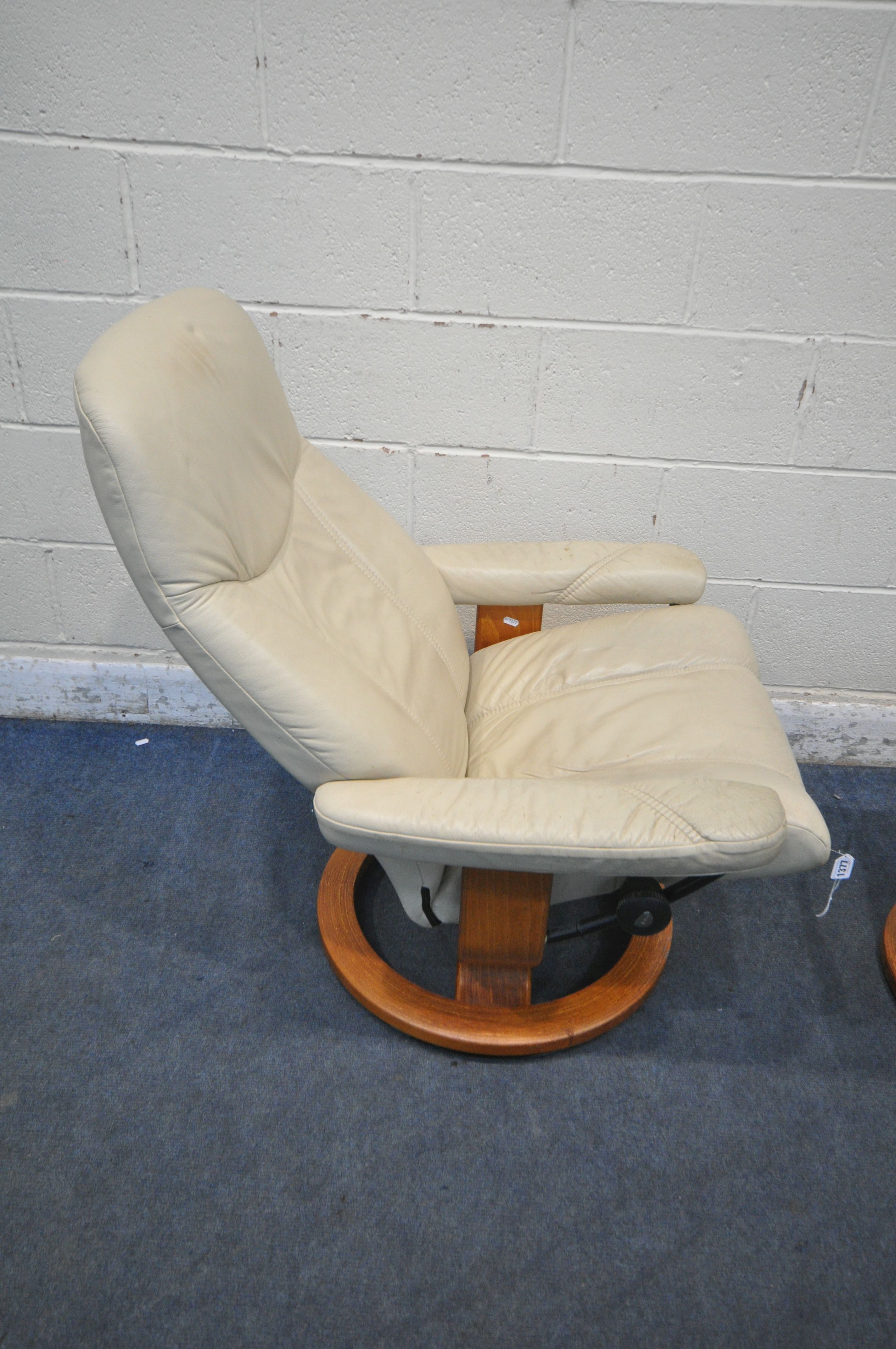 AN EKORNES STRESSLESS CREAM LEATHER SWIVEL RECLINING ARMCHAIR, along with a footstool (condition - Image 2 of 5
