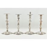 A GEORGE V SILVER SET OF FOUR CANDLESTICKS IN GEORGE II STYLE, with removable shaped square drip