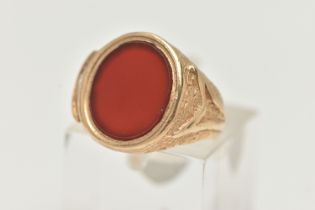 A 9CT GOLD SIGNET RING, designed as an oval carnelian panel within a tapered ring mount with
