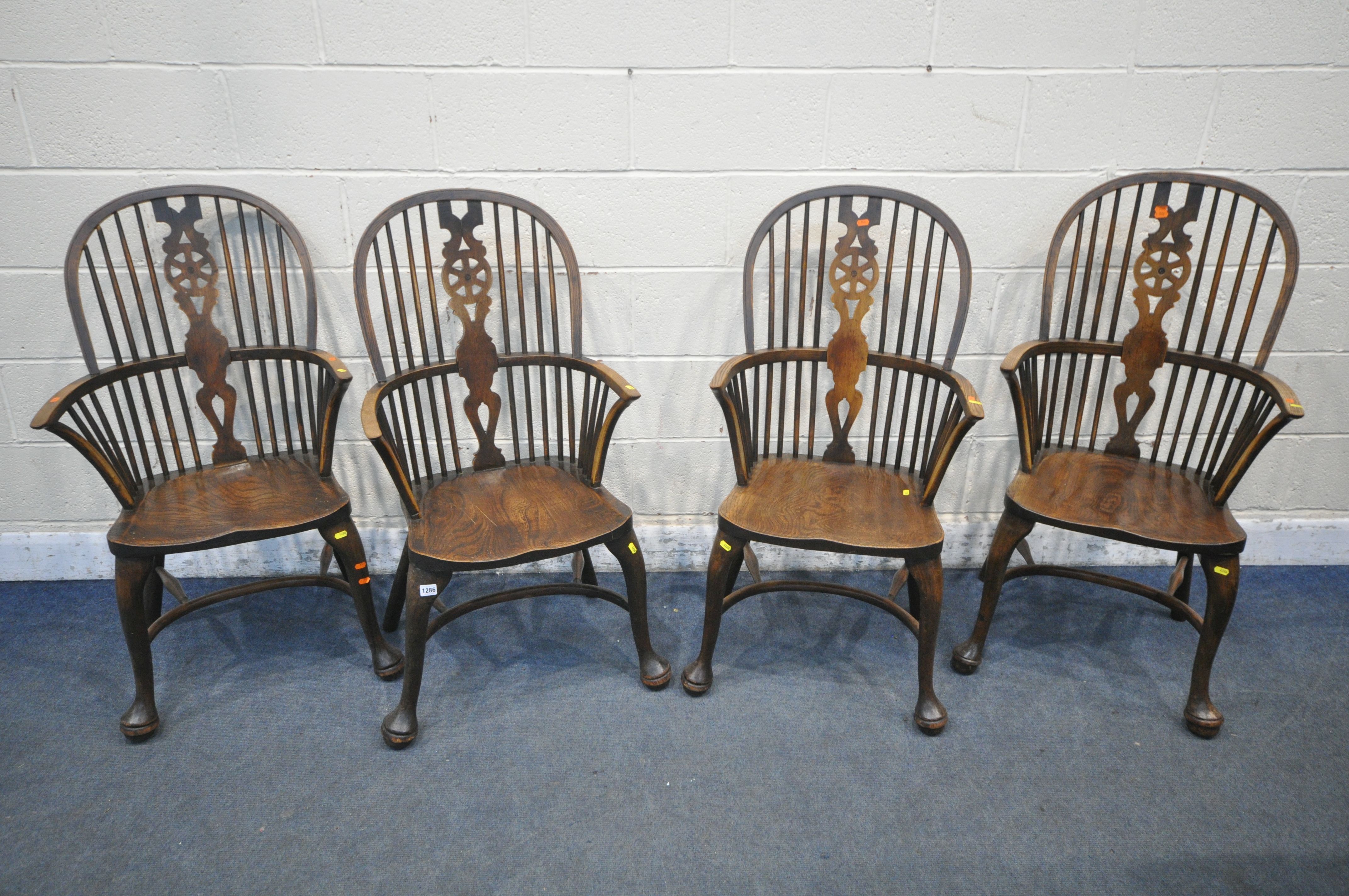 A SET OF FOUR EARLY 20TH CENTURY ELM AND BEECH HOOP BACK WINDSOR ARMCHAIR, with a wheel splat