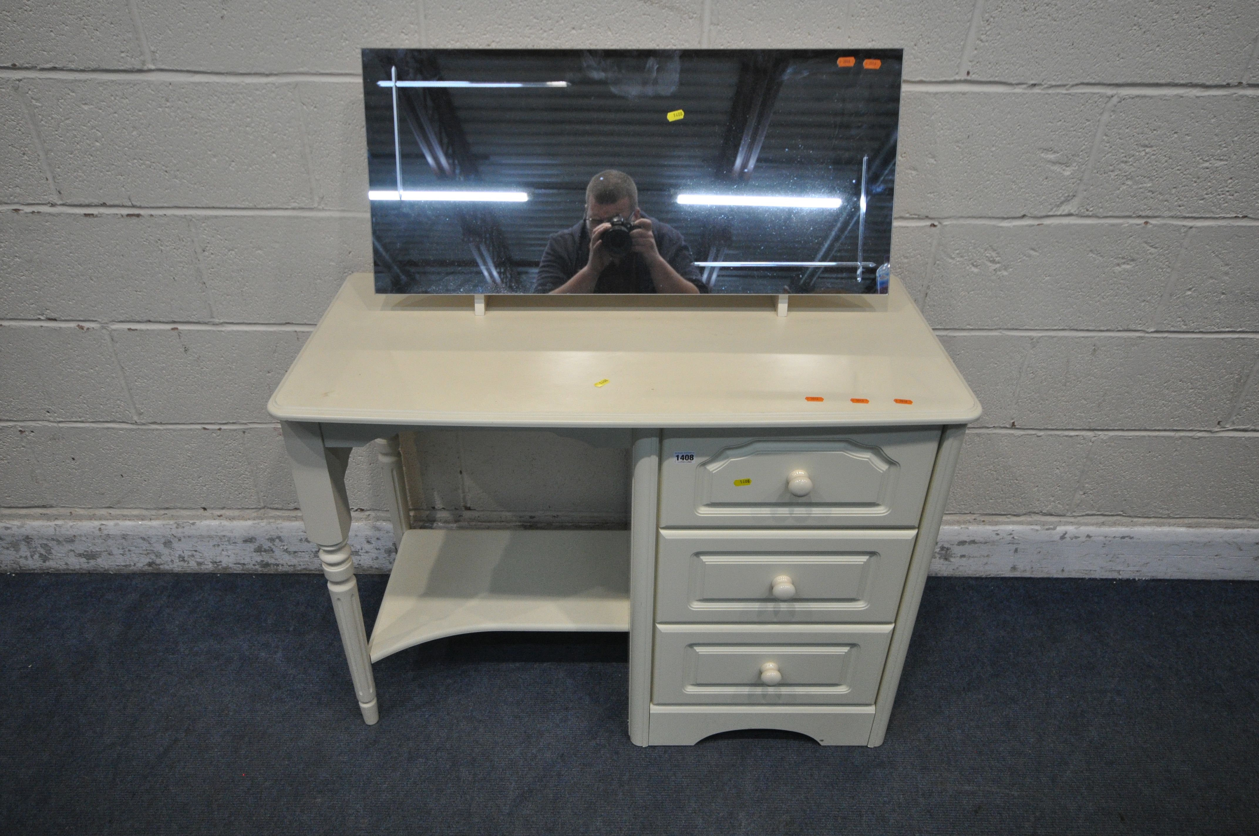 A CREAM DRESSING TABLE, fitted with three drawers, along with a rectangular dressing mirror, width
