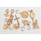 A SMALL BAG OF 9CT GOLD CHARMS, to include a bull, bell, bellowers, anchor, St. Christopher,