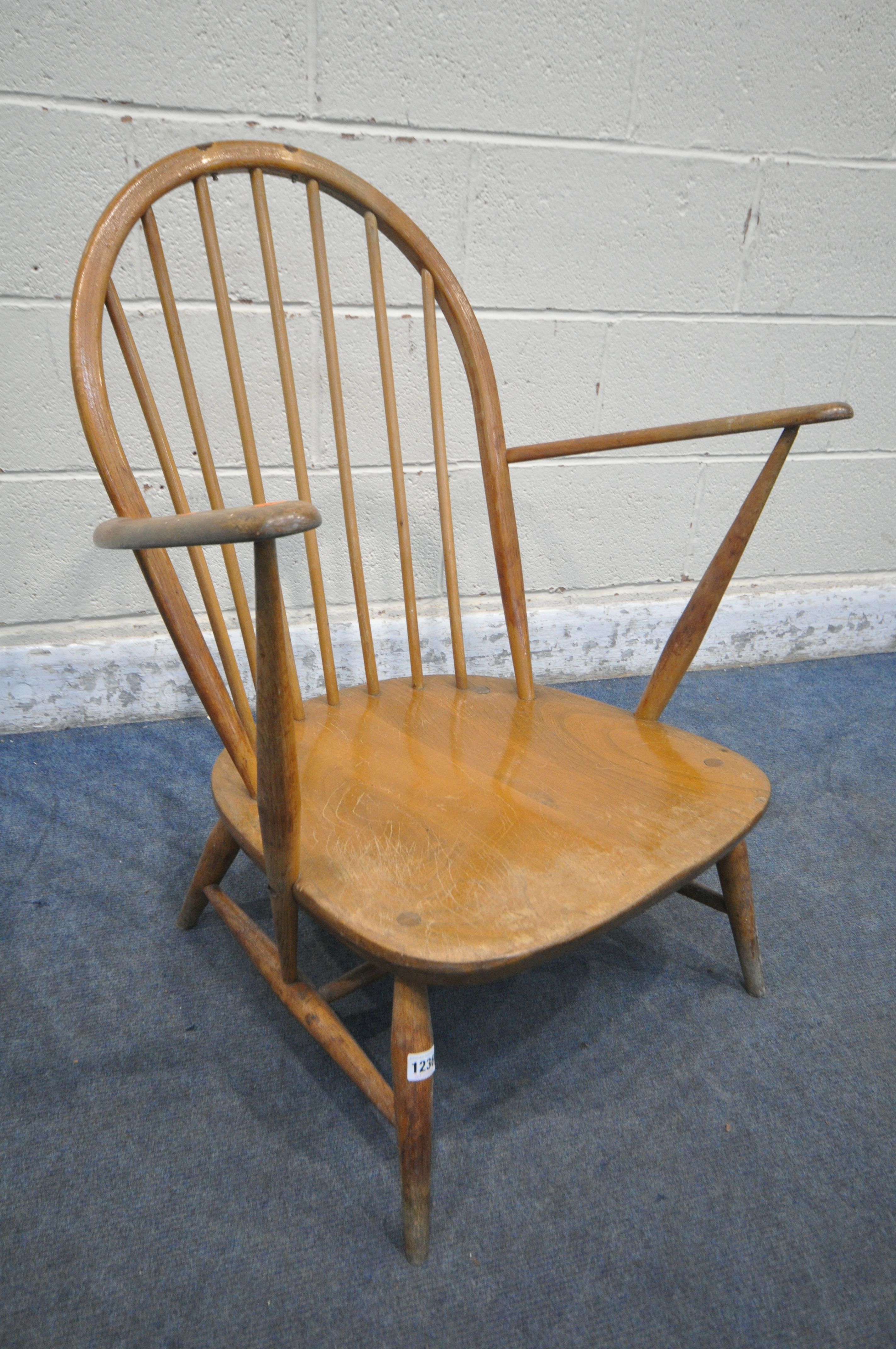 A MID CENTURY ERCOL WINDSOR ARMCHAIR, with a spindle hoop back (condition report: water stained
