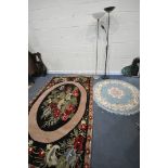 A WOOLLEN FLORAL RUG, on a black ground, 248cm x 168cm, along with a Chinese blue circular rug,