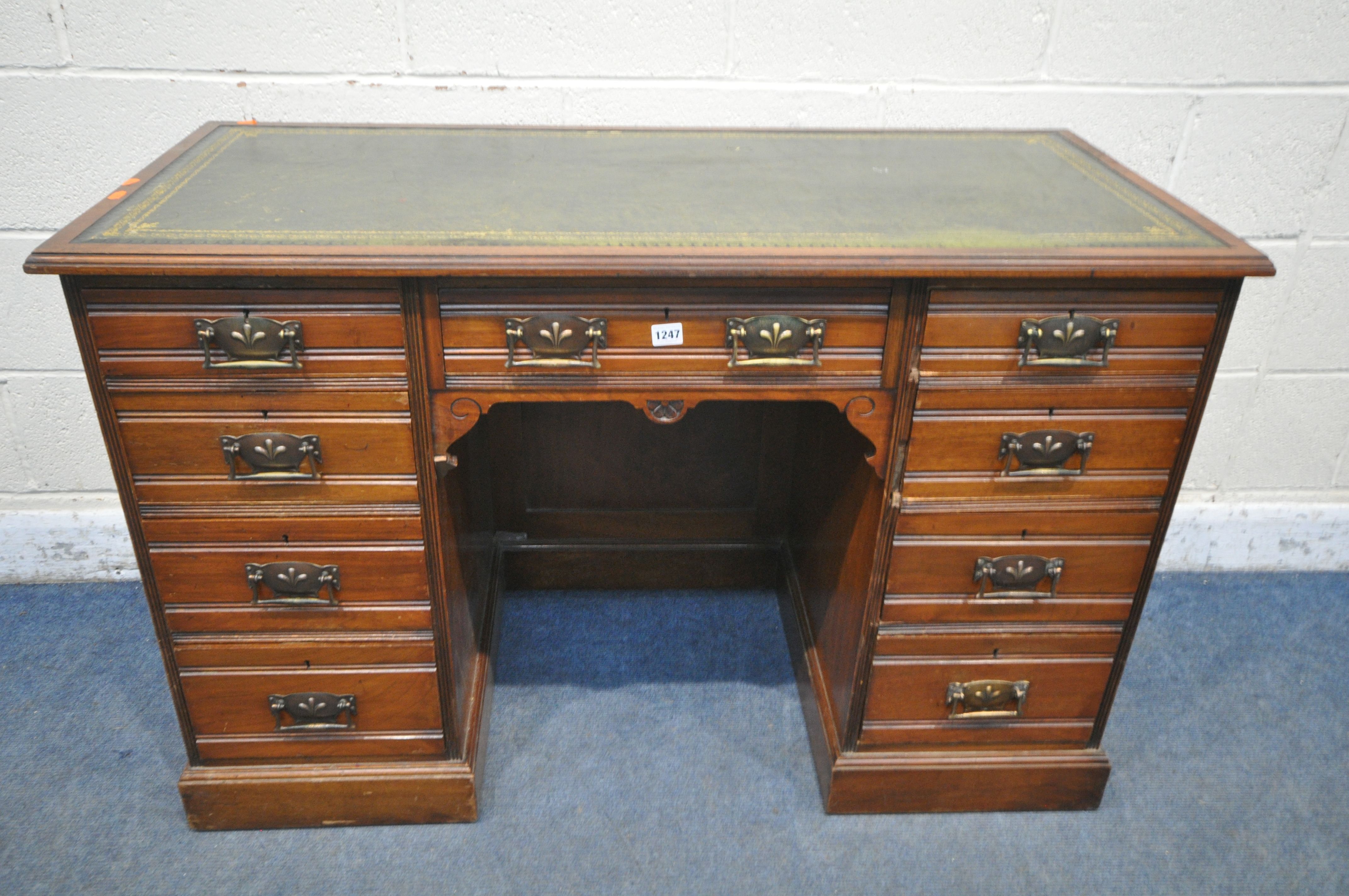AN EDWARDIAN WALNUT KNEE HOLE DESK, with a green gilt tooled leather inlay writing surface, and an