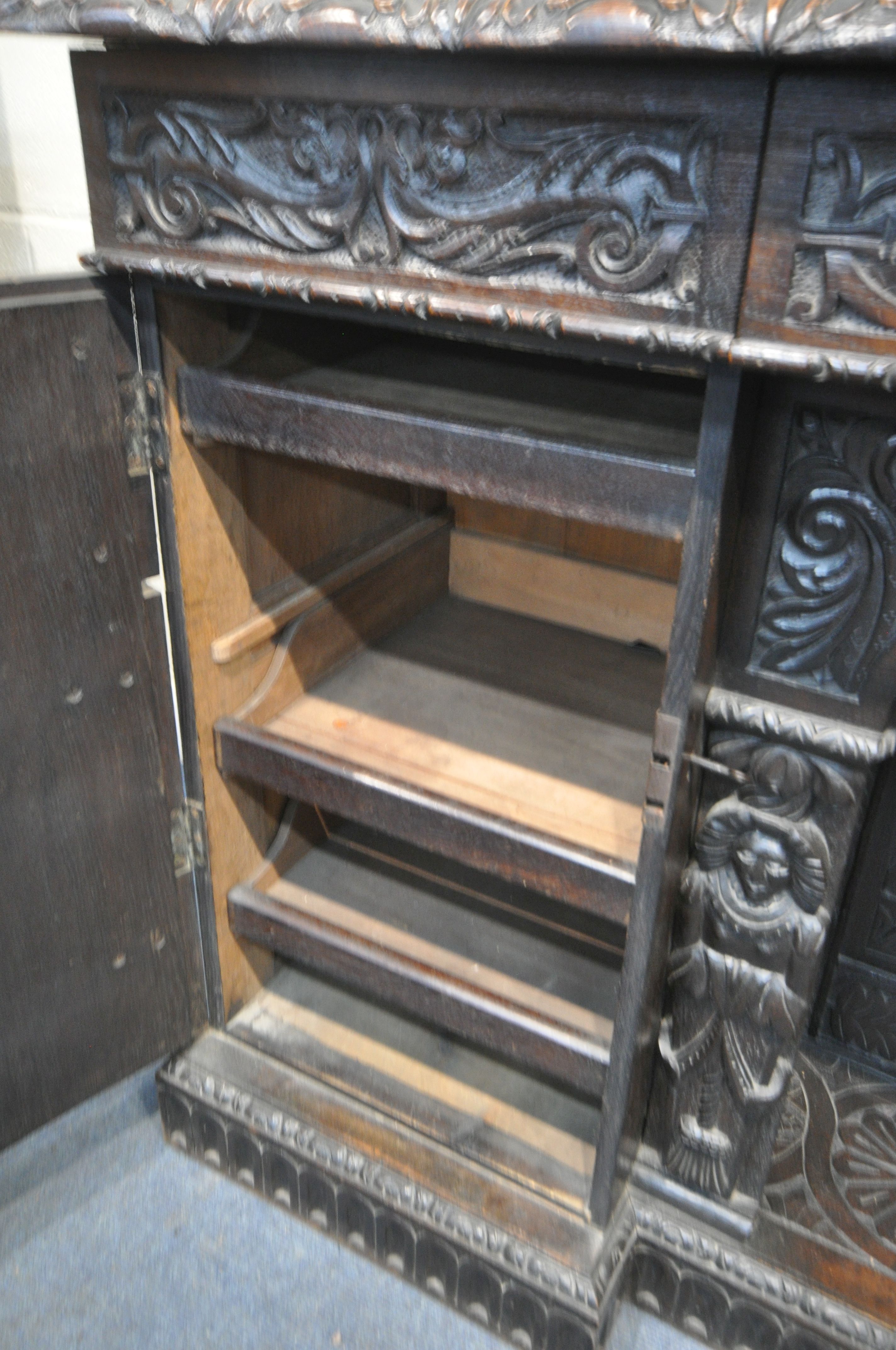 A 19TH CENTURY HEAVILY CARVED OAK SIDEBOARD, the raised back with panelling and shelf, fitted with - Image 9 of 10