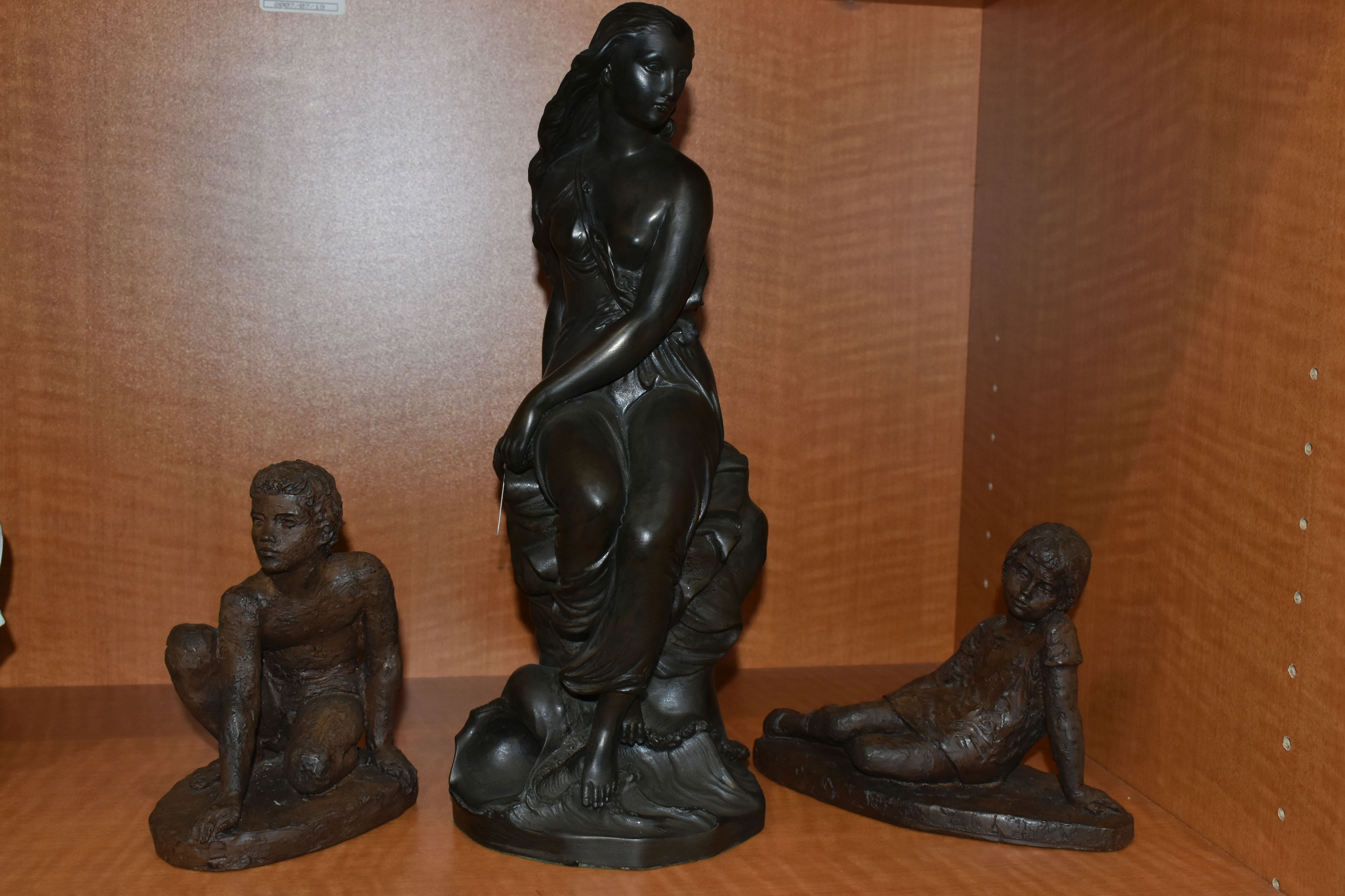 A BRONZED RESIN MODEL OF A SCANTILY CLAD SEATED CLASSICAL FEMALE AND TWO KARIN JONZEN BRONZED