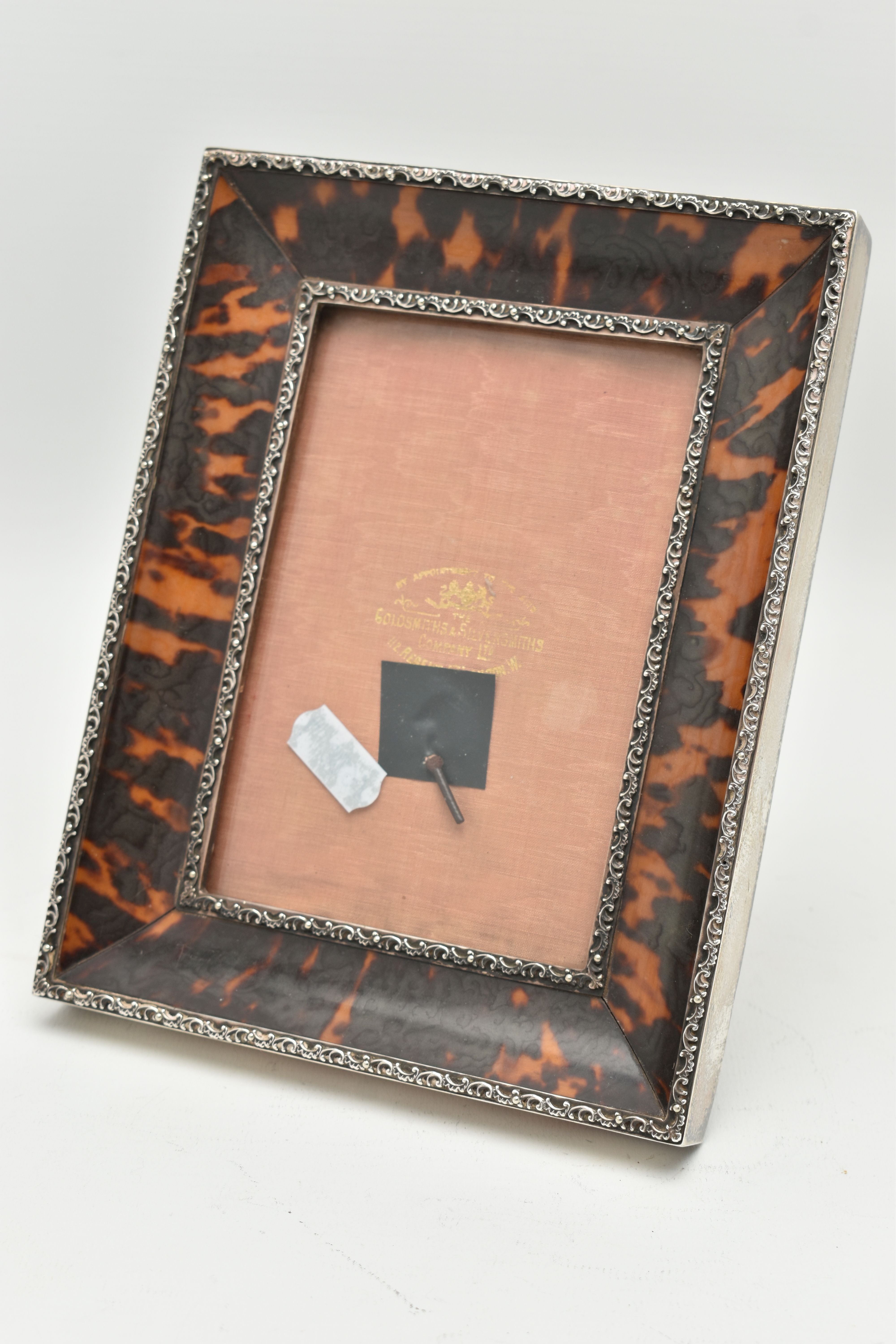 A GEORGE V PHOTO FRAME, a rectangular form photo frame, designed as silver foliage borders with