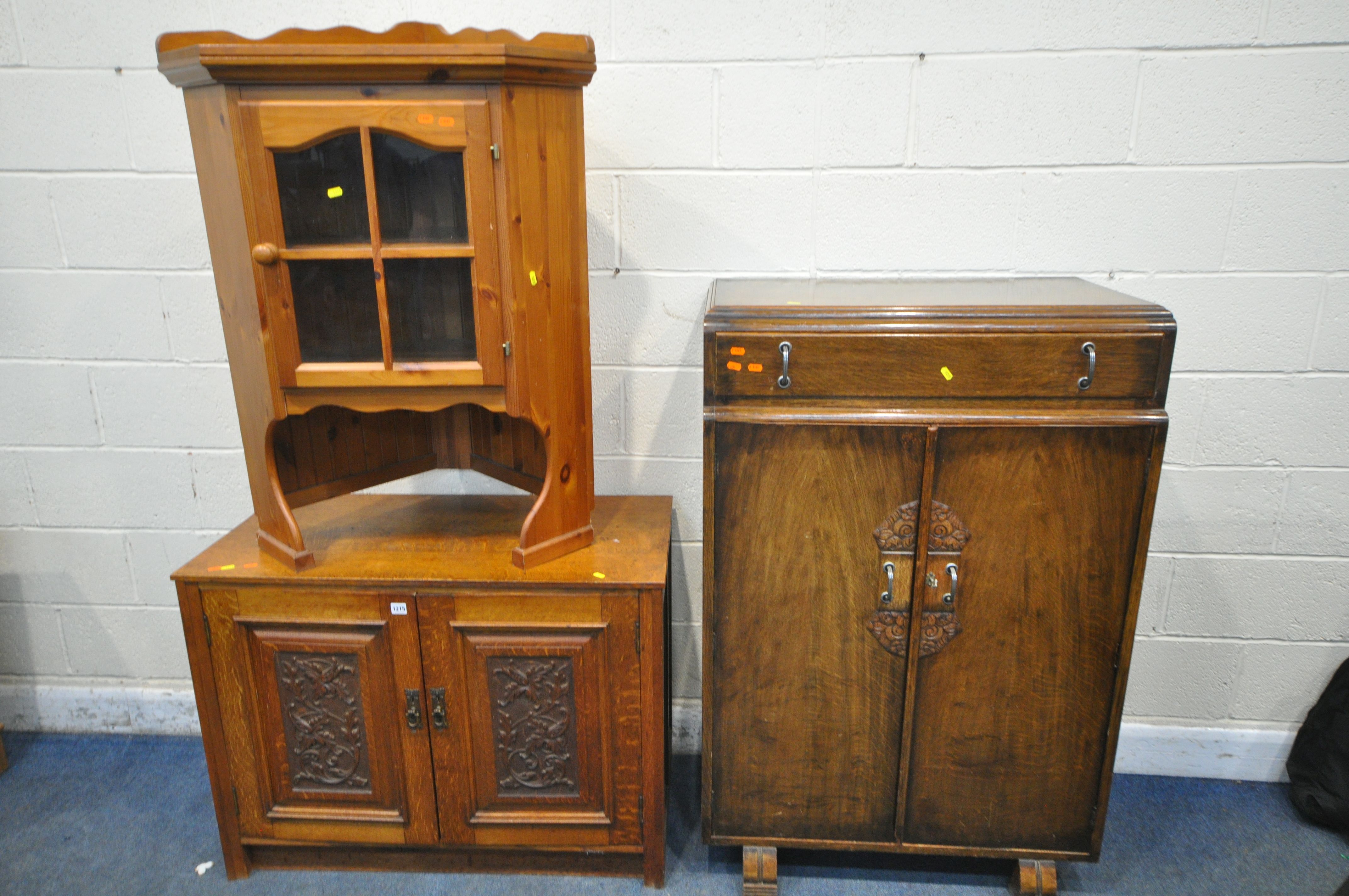 AN OAK TWO DOOR CUPBOARD, with carved foliate panels, width 100cm x depth 49cm x height 75cm,