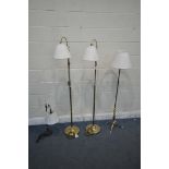 A PAIR OF BRASS STANDARD LAMPS, with an adjustable height, along with another brass lamp with a