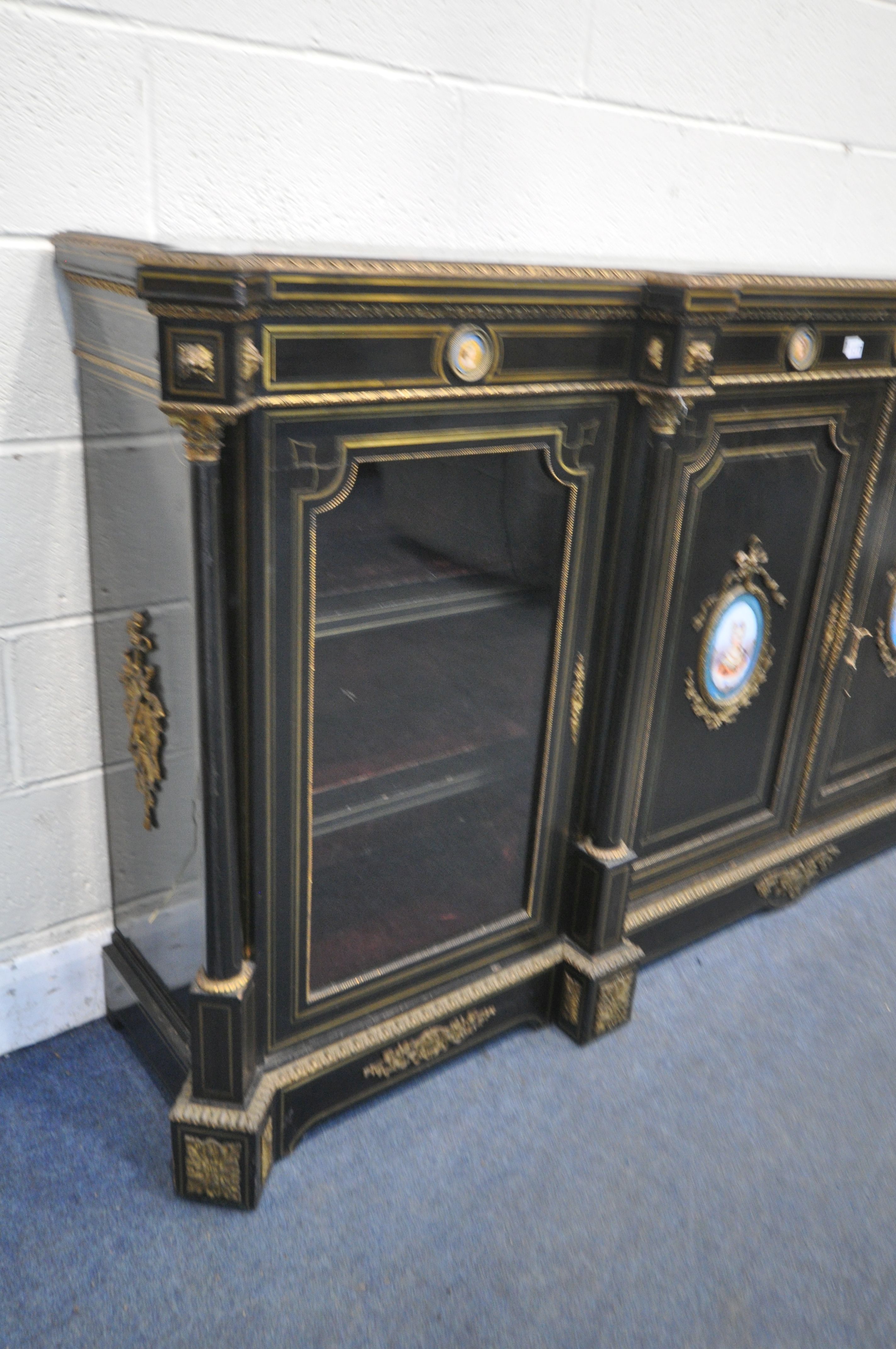 A 19TH CENTURY EBONISED AND GILT BRASS CREDENZA, with four moulded tops supporting Corinthian - Image 2 of 7