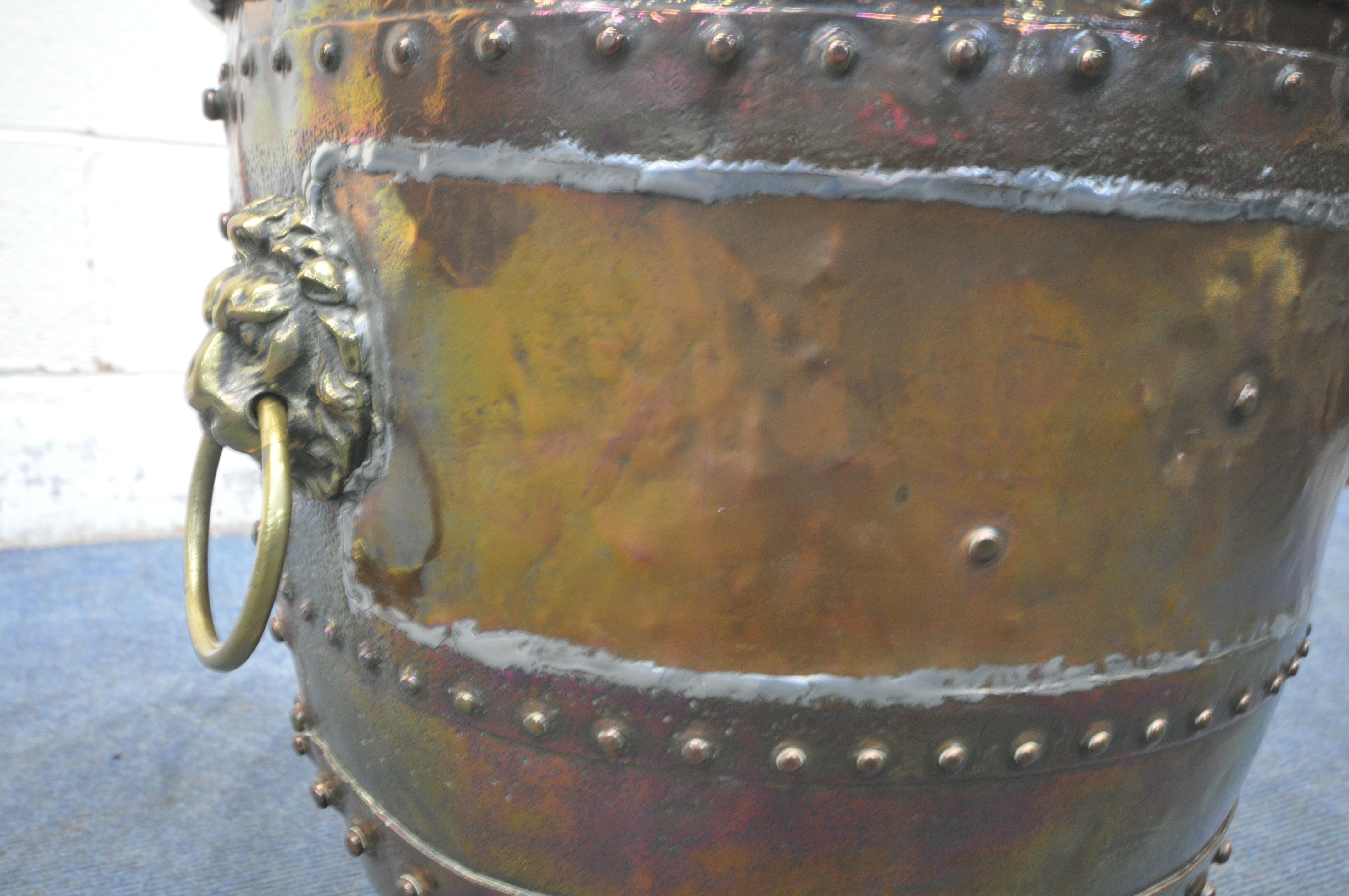 A 19TH CENTURY RIVETED BRASS AND COPPER COAL BUCKET, with lions head handles, and triple paw feet, - Image 5 of 5