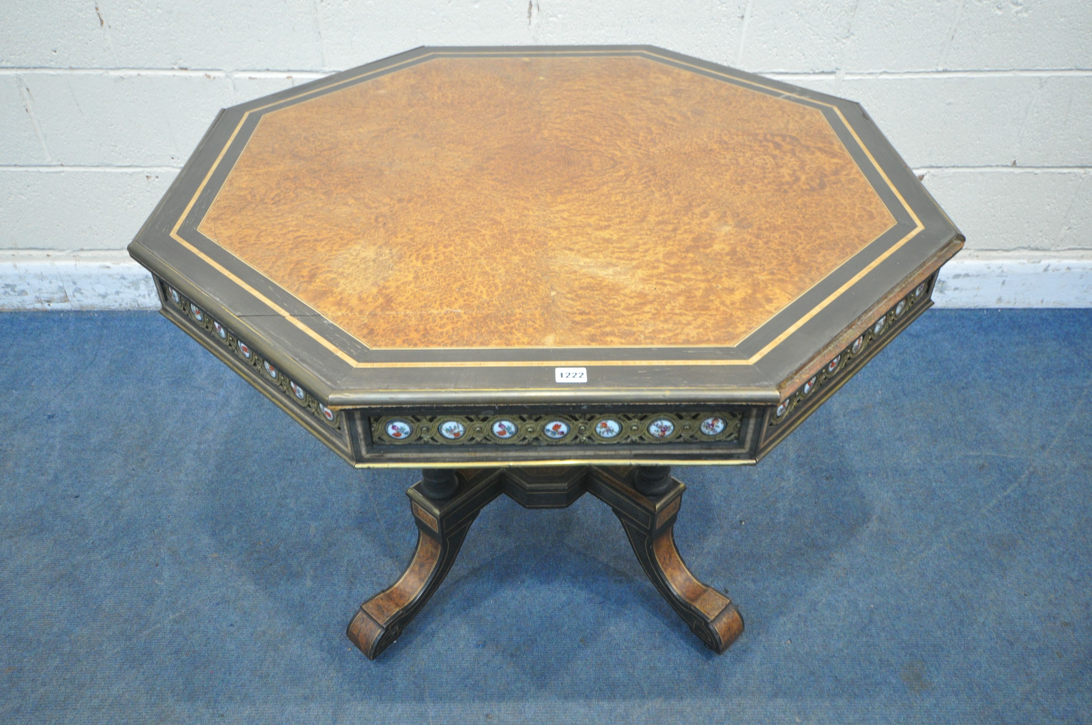 A MID TO LATE 19TH CENTURY EBONISED AND AMBOYNA OCTAGONAL CENTRE TABLE, with brass and porcelain