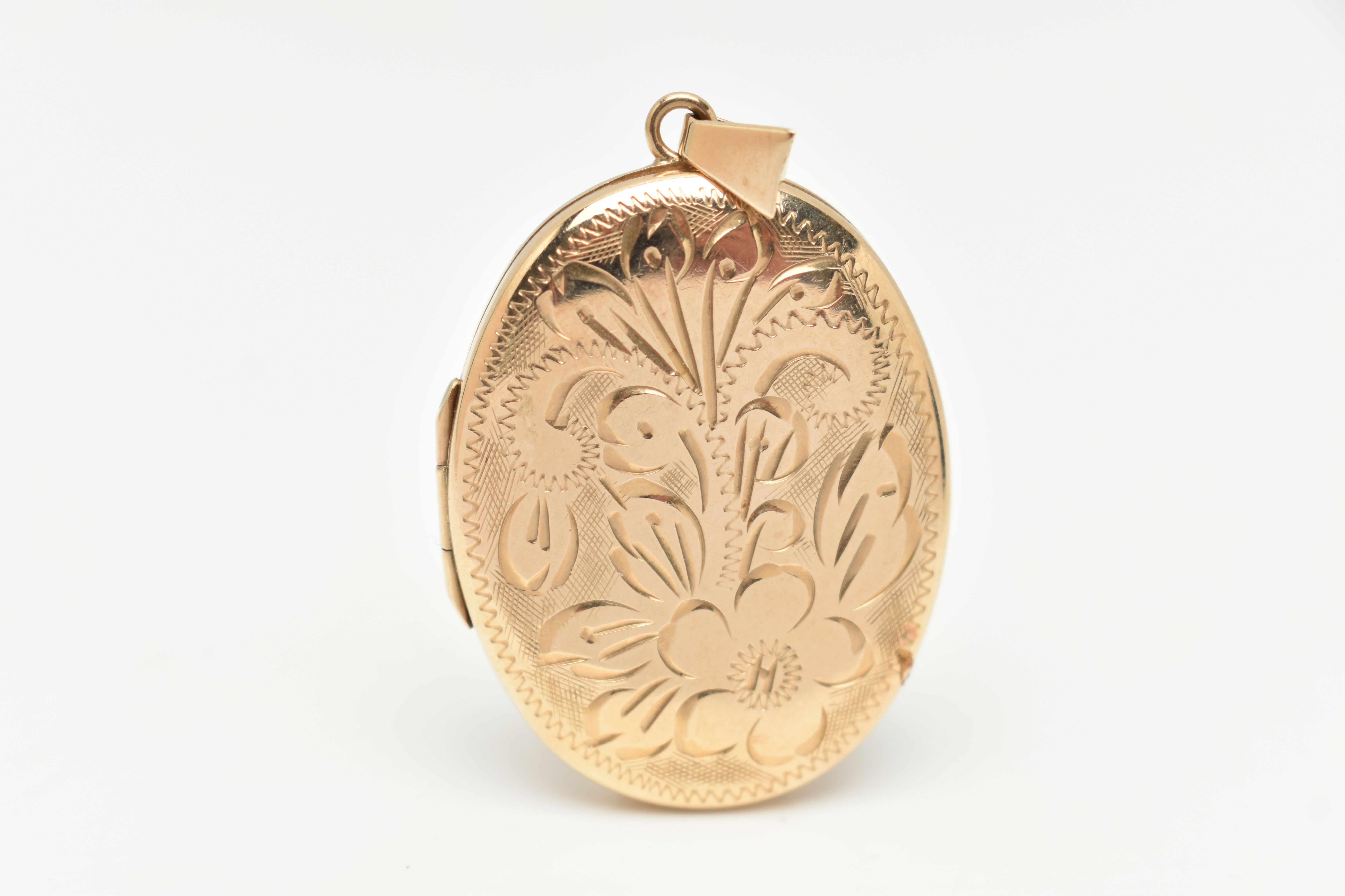 A 9CT GOLD OVAL LOCKET, floral pattern, hallmarked 9ct Birmingham, fitted with a tapered bail,