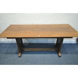 AN OAK TRESTLE DINING TABLE, united by a floor stretcher, length 182cm x 87cm x height 77cm (