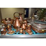 A VARIETY OF COPPERWARE, comprising a selection of measuring vessels, tankards, an 'arts and crafts'