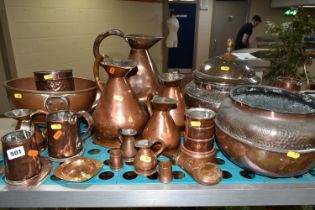 A VARIETY OF COPPERWARE, comprising a selection of measuring vessels, tankards, an 'arts and crafts'