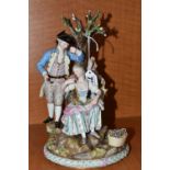 A LATE 19TH CENTURY MEISSEN PORCELAIN FIGURE GROUP OF A COURTING COUPLE BENEATH A TREE WITH FLOWERS,