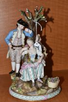 A LATE 19TH CENTURY MEISSEN PORCELAIN FIGURE GROUP OF A COURTING COUPLE BENEATH A TREE WITH FLOWERS,