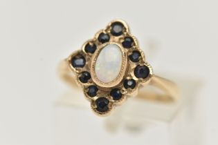 A 9CT GOLD OPAL AND SAPPHIRE RING, designed as a central oval opal cabochon within a circular