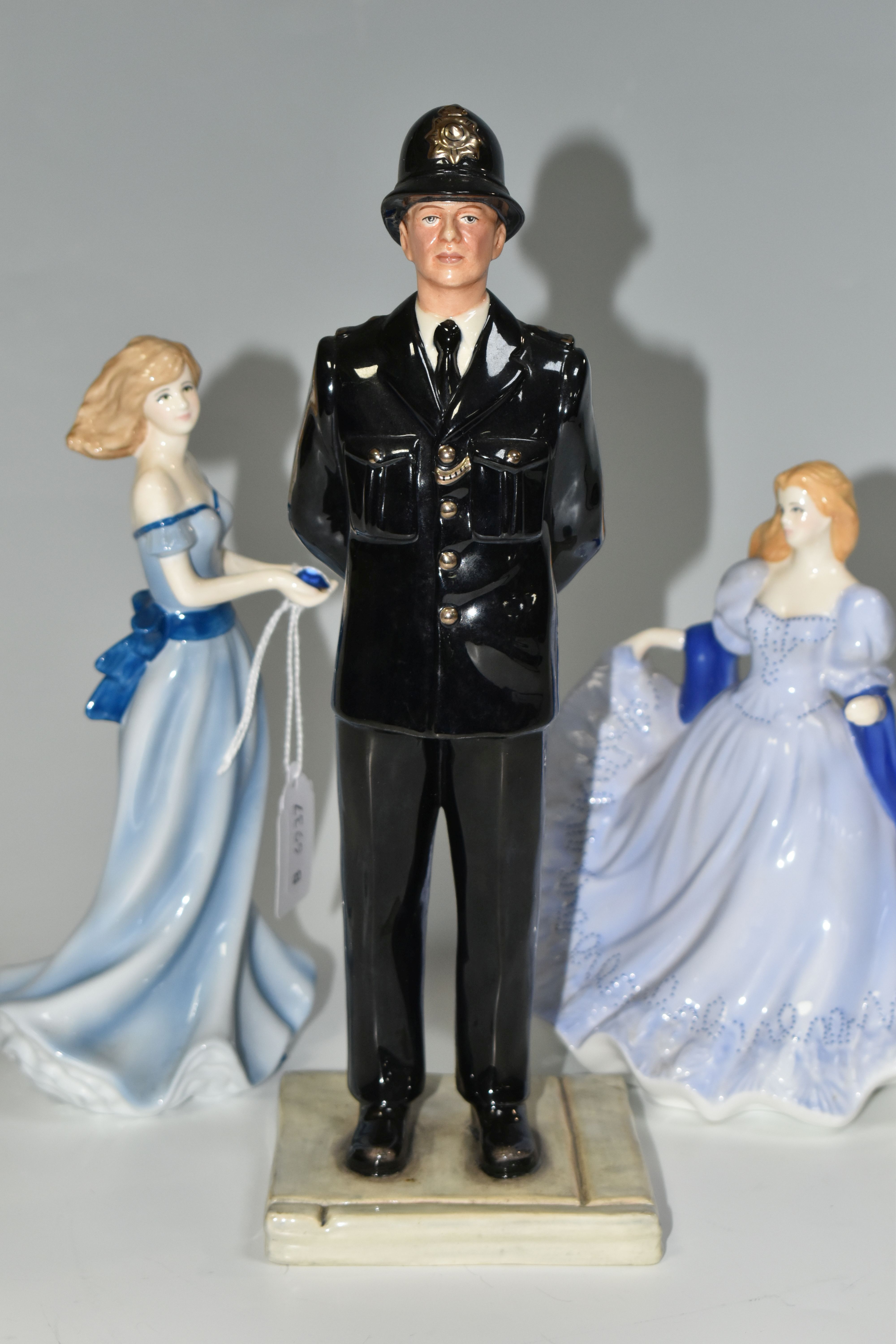 TWO ROYAL WORCESTER FIGURINES AND A ROYAL DOULTON 'BRITISH POLICEMAN' FIGURE, comprising a Royal - Image 4 of 5