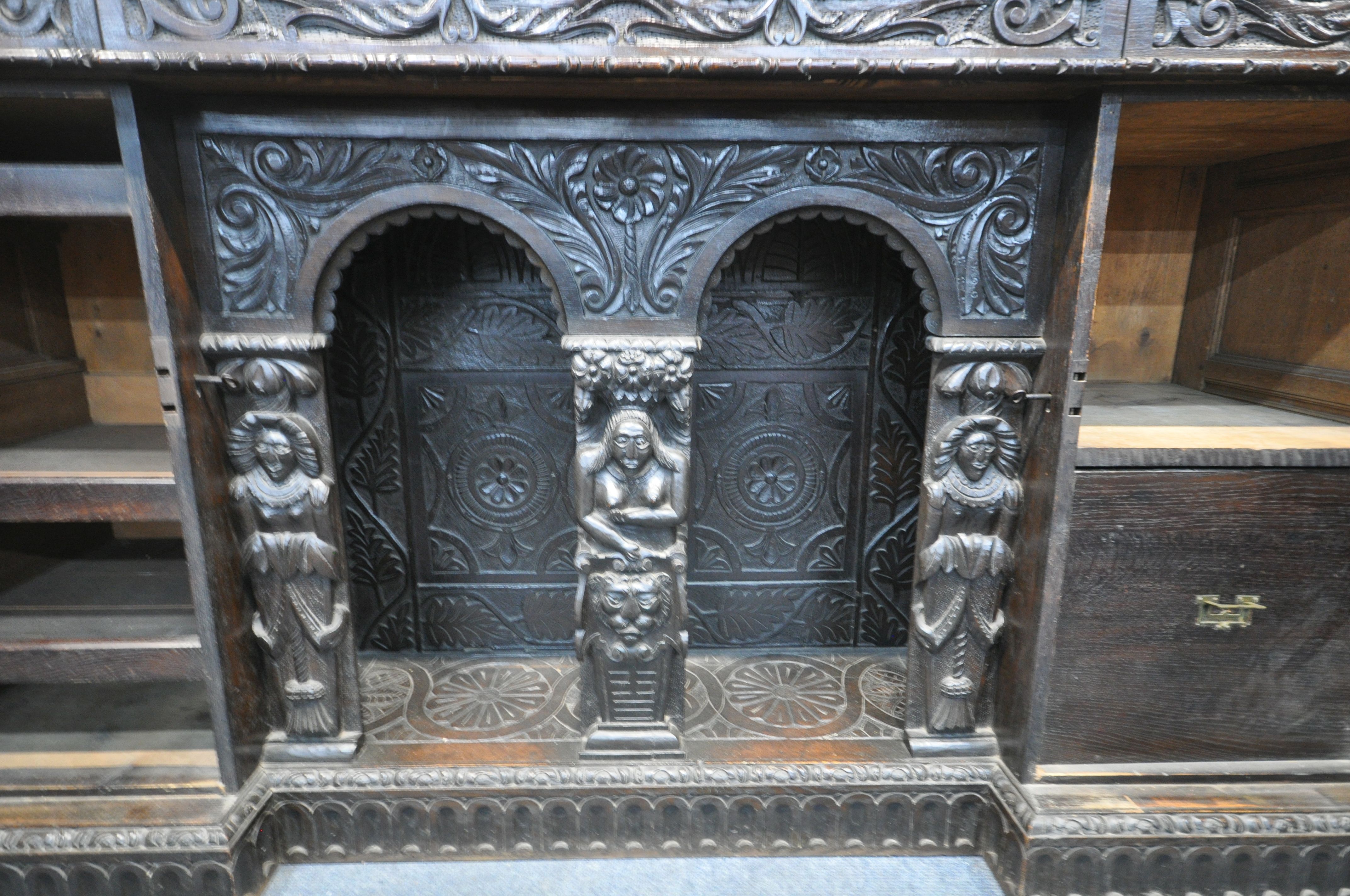 A 19TH CENTURY HEAVILY CARVED OAK SIDEBOARD, the raised back with panelling and shelf, fitted with - Image 10 of 10