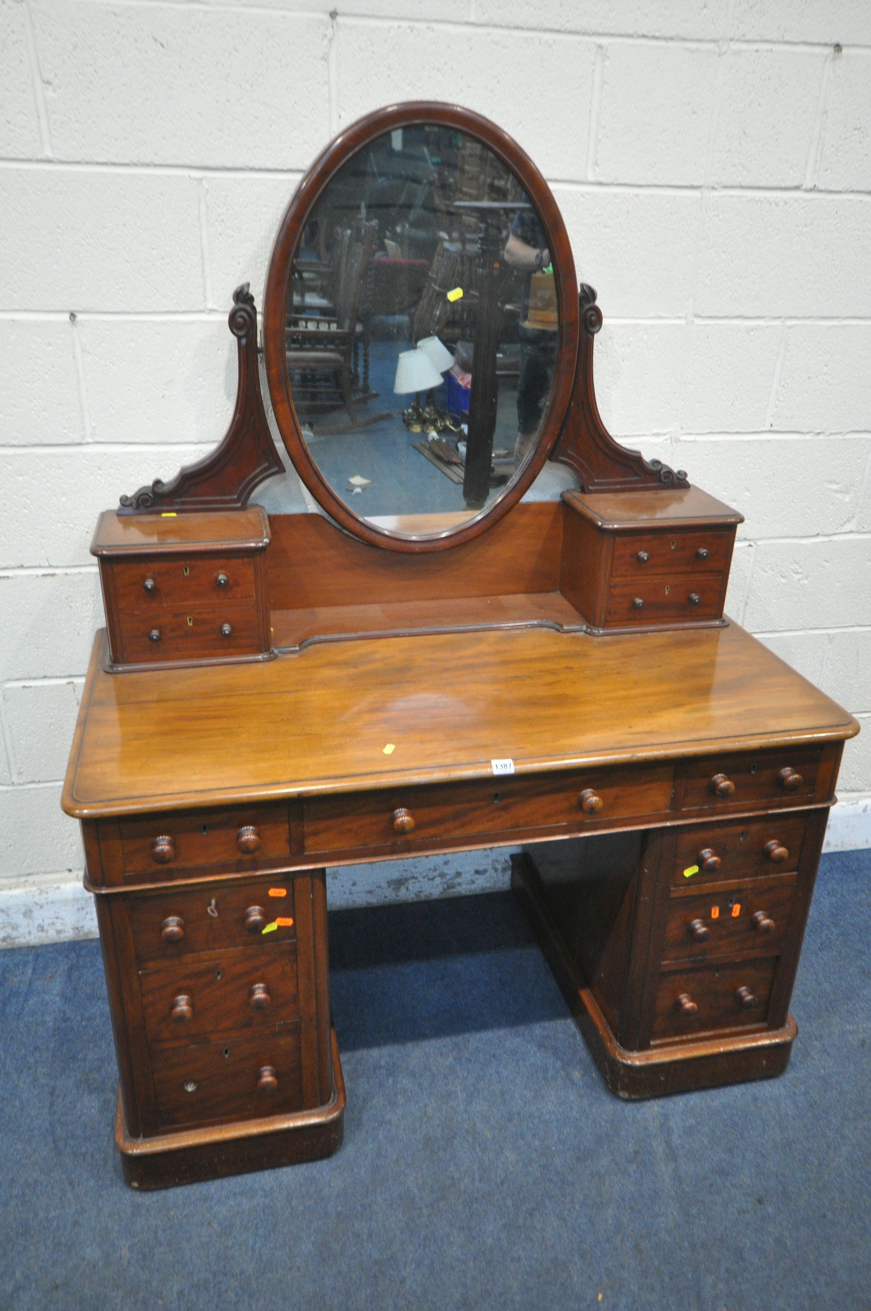 A 19TH CENTURY MAHOGANY TWIN PEDESTAL DRESSING TABLE, with an oval mirror, fitted with an