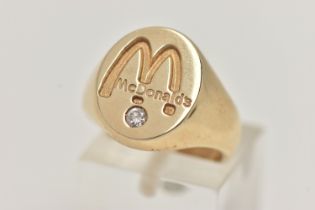 A 9CT GOLD 'MCDONALDS' SIGNET RING, a yellow gold oval signet, signed 'McDonalds', flush set with
