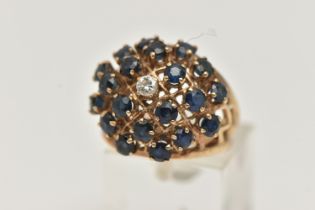 A 9CT GOLD SAPPHIRE AND DIAMOND BOMBE RING, twenty circular cut sapphires and a single round