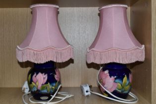 A PAIR OF MOORCROFT POTTERY CONVERTED GINGER JAR TABLE LAMPS, tube lined in the Magnolia pattern