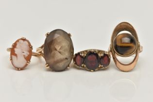 FOUR GEM SET RINGS, to include a large oval cut smoky quartz, approximate length 22mm, prong set