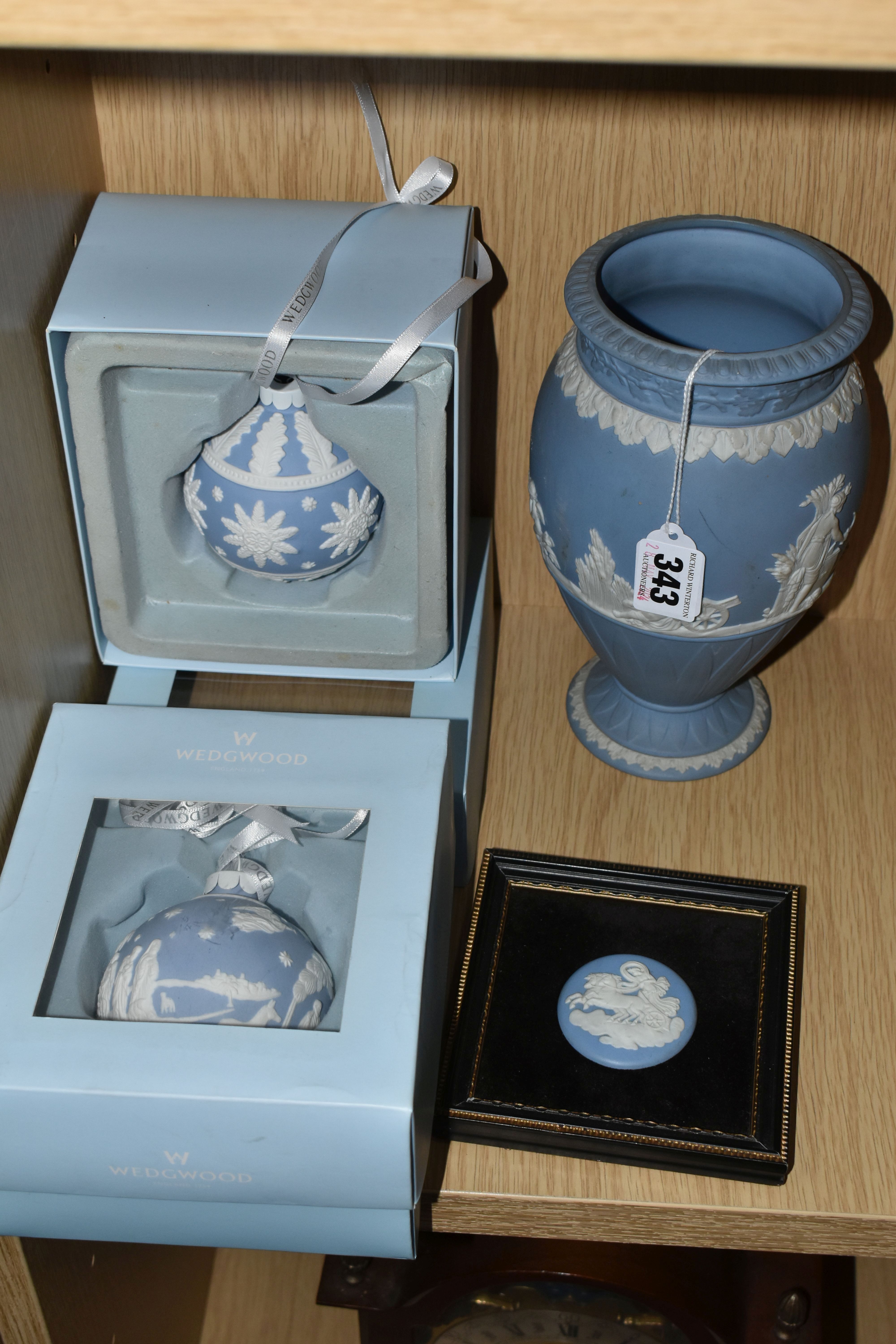 A GROUP OF WEDGWOOD BLUE JASPERWARE, comprising two boxed Christmas baubles, a framed plaque and a