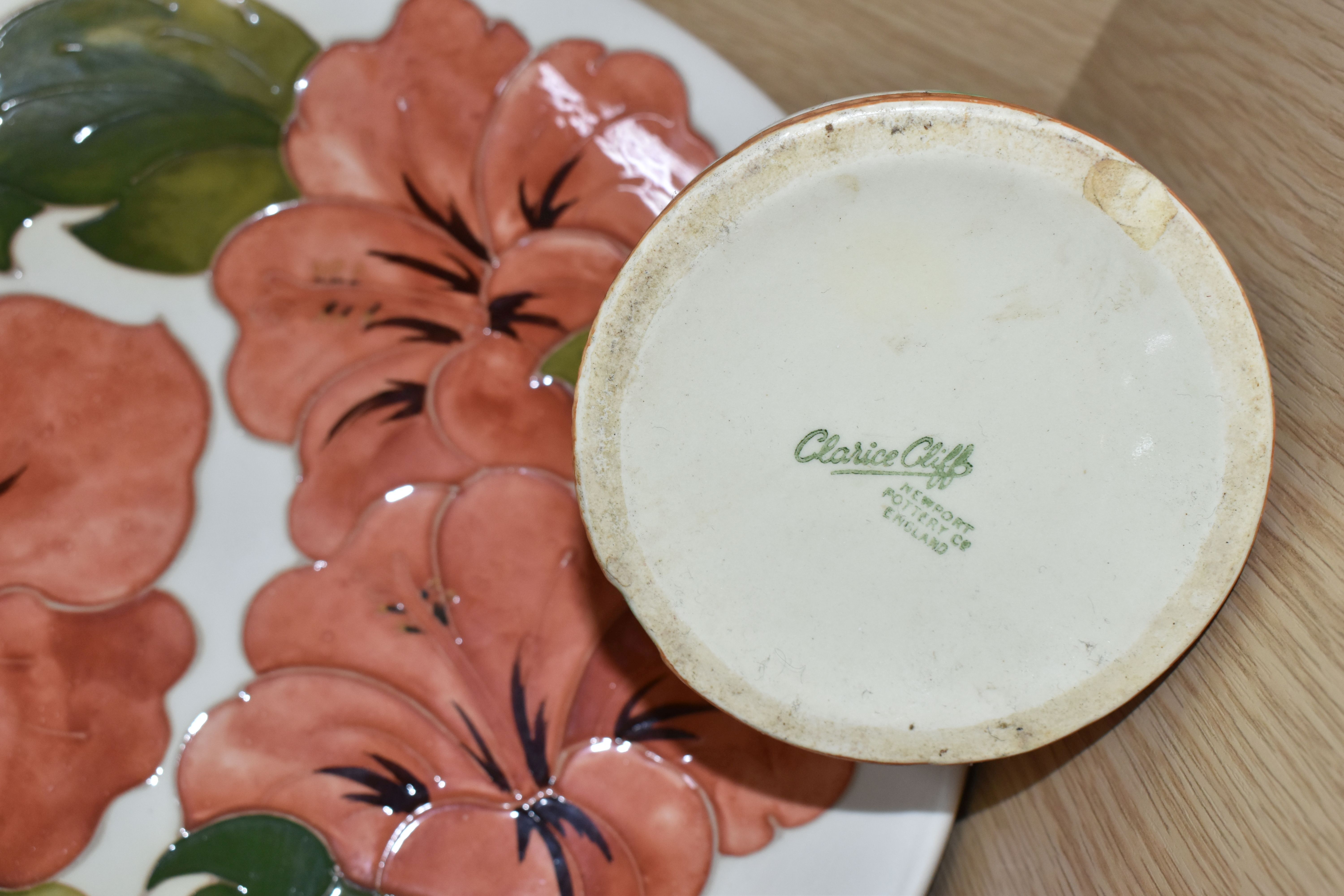 A MOORCROFT POTTERY 'HIBISCUS' PATTERNED PLATE AND A CLARICE CLIFF SUGAR BOWL, comprising a coral - Image 4 of 4