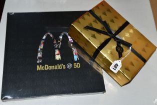 A McDONALD'S @ 50 HARDBACK BOOK, published in 2005 covers the history and the advertising of