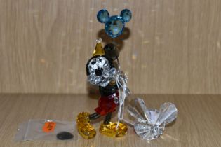 A SWAROVSKI CRYSTAL 'MICKEY MOUSE - CELEBRATION' FIGURE, depicts Mickey in a party hat, holding a