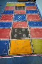A LARGE RECTANGULAR MOROCCAN BERBER RUG, with an arrangement of squares and patterns, of various