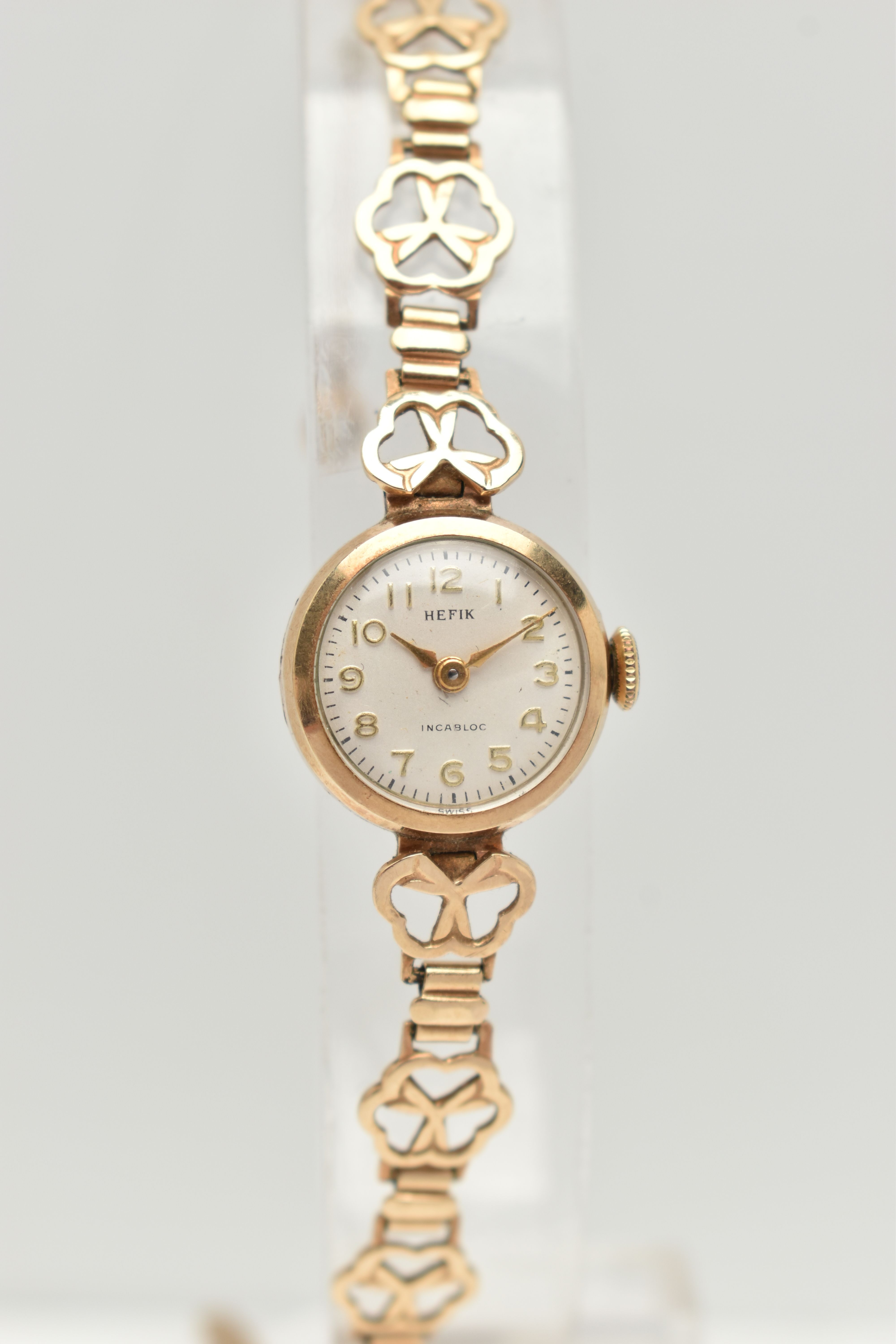 A LADIES 9CT GOLD WRISTWATCH, manual wind, round silver dial signed 'Hefix', Arabic numerals, gold