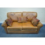 A TANNED LEATHER TWO SEATER SOFA, with double sided cushions, and three scatter cushions, length