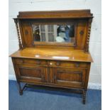 AN EARLY 20TH CENTURY OAK MIRROR BACK SIDEBOARD, the top with a rectangular bevelled mirror plate,