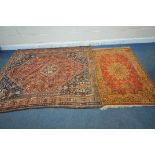 A RECTANGULAR RED GROUND RUG, with a central medallion, repeating geometric patterns and a multi-