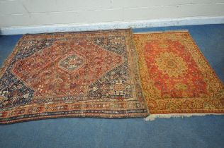 A RECTANGULAR RED GROUND RUG, with a central medallion, repeating geometric patterns and a multi-